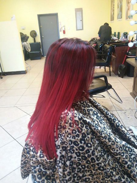 woman with long pink hair sitting in salon business loan in alamo TX from Alamo Texas EDC 