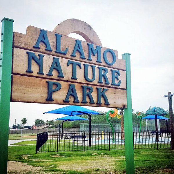 Outdoor wooden sign that reads Alamo Nature Park
