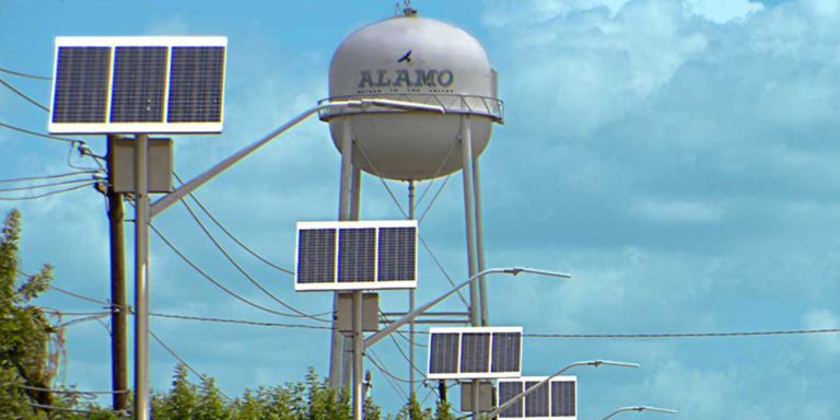 Large water tower and sun panels in the city of alamo